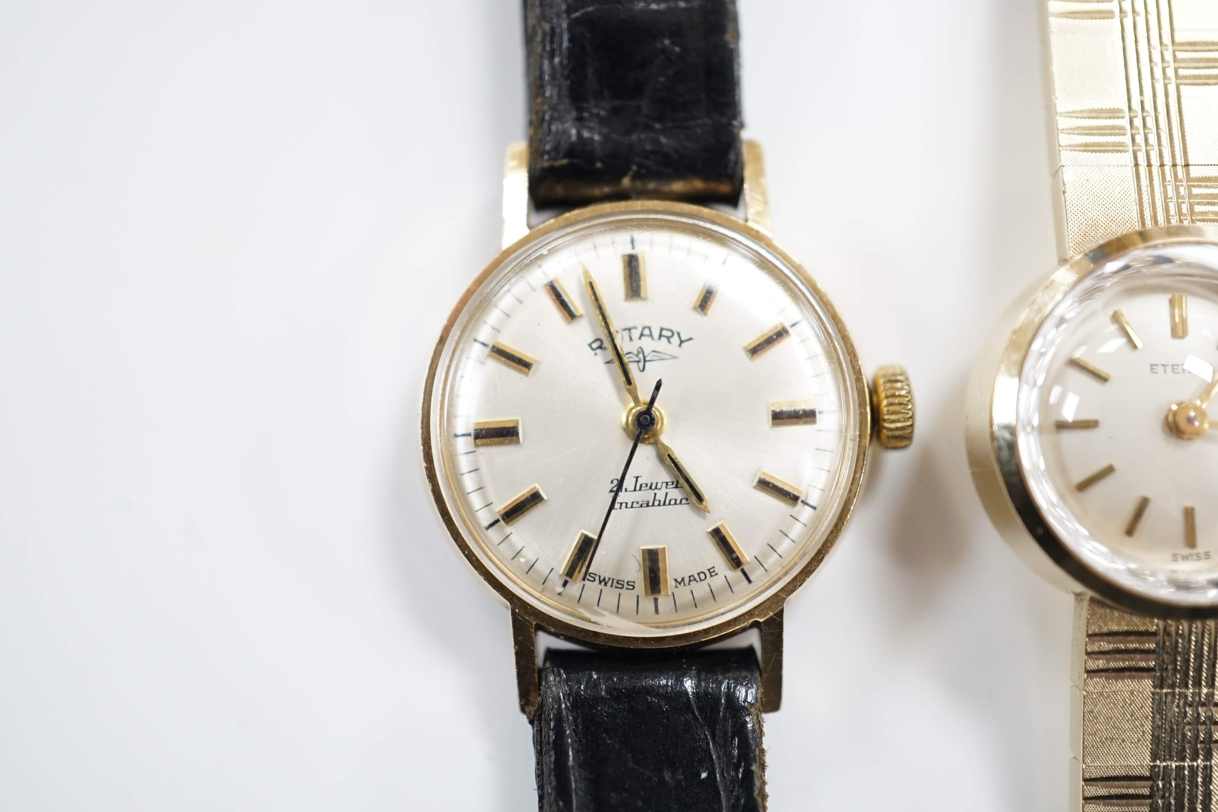 A lady's 9ct gold Eterna manual wind wrist watch, on a 9ct gold integral bracelet, overall 16.2cm, gross weight 23.7 grams, together with a lady's 9ct gold Rotary manual wind wrist watch, on a leather strap.